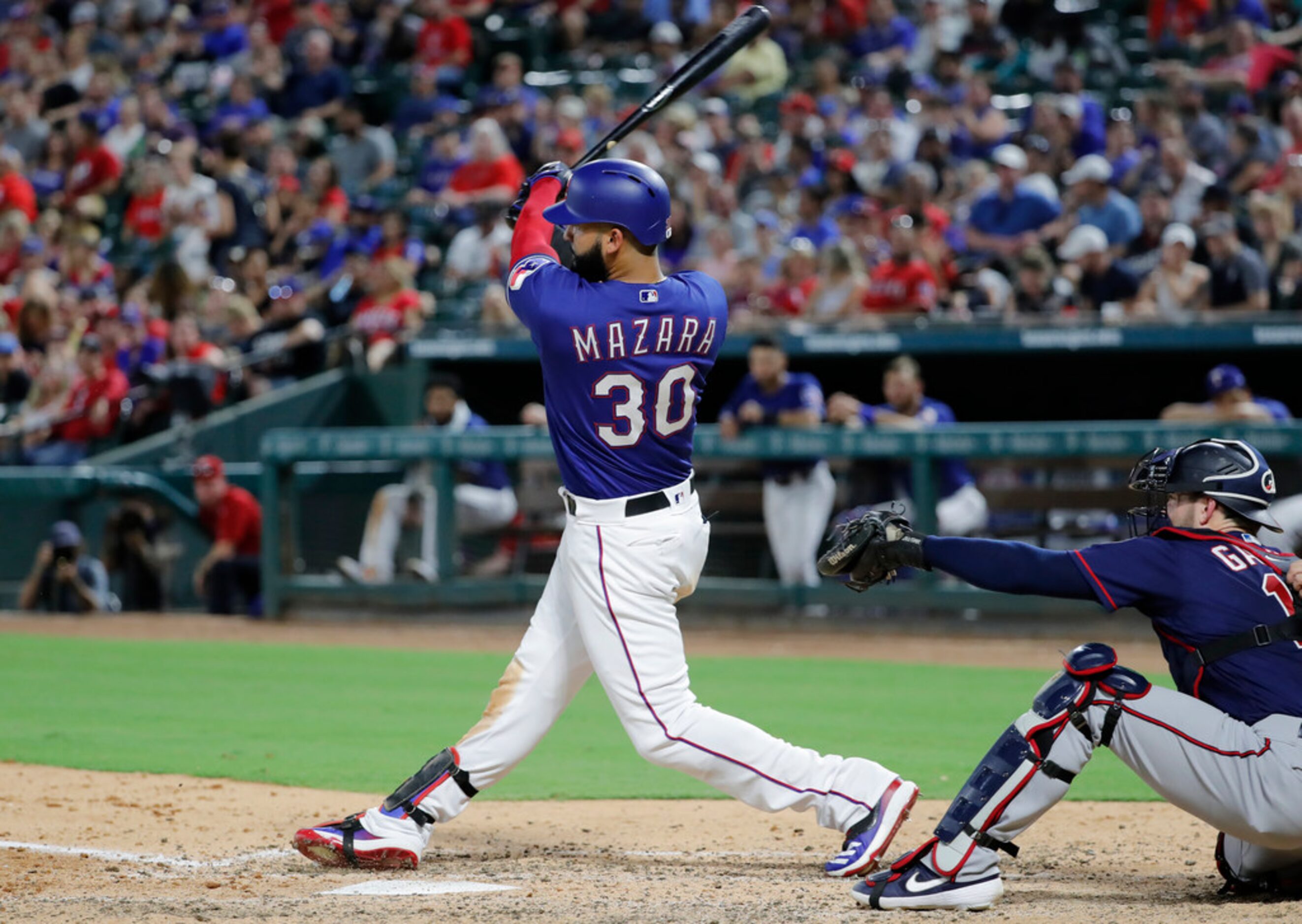 Texas Rangers' Nomar Mazara follows through on a two-run double off Minnesota Twins' Jake...