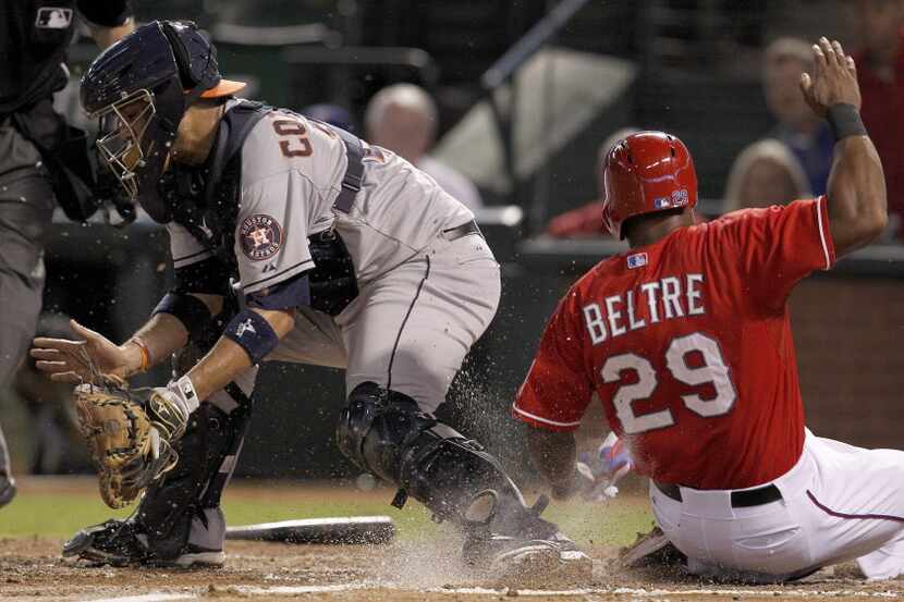 Texas Rangers third baseman Adrian Beltre (29) scores ahead of Houston Astros catcher Carlos...