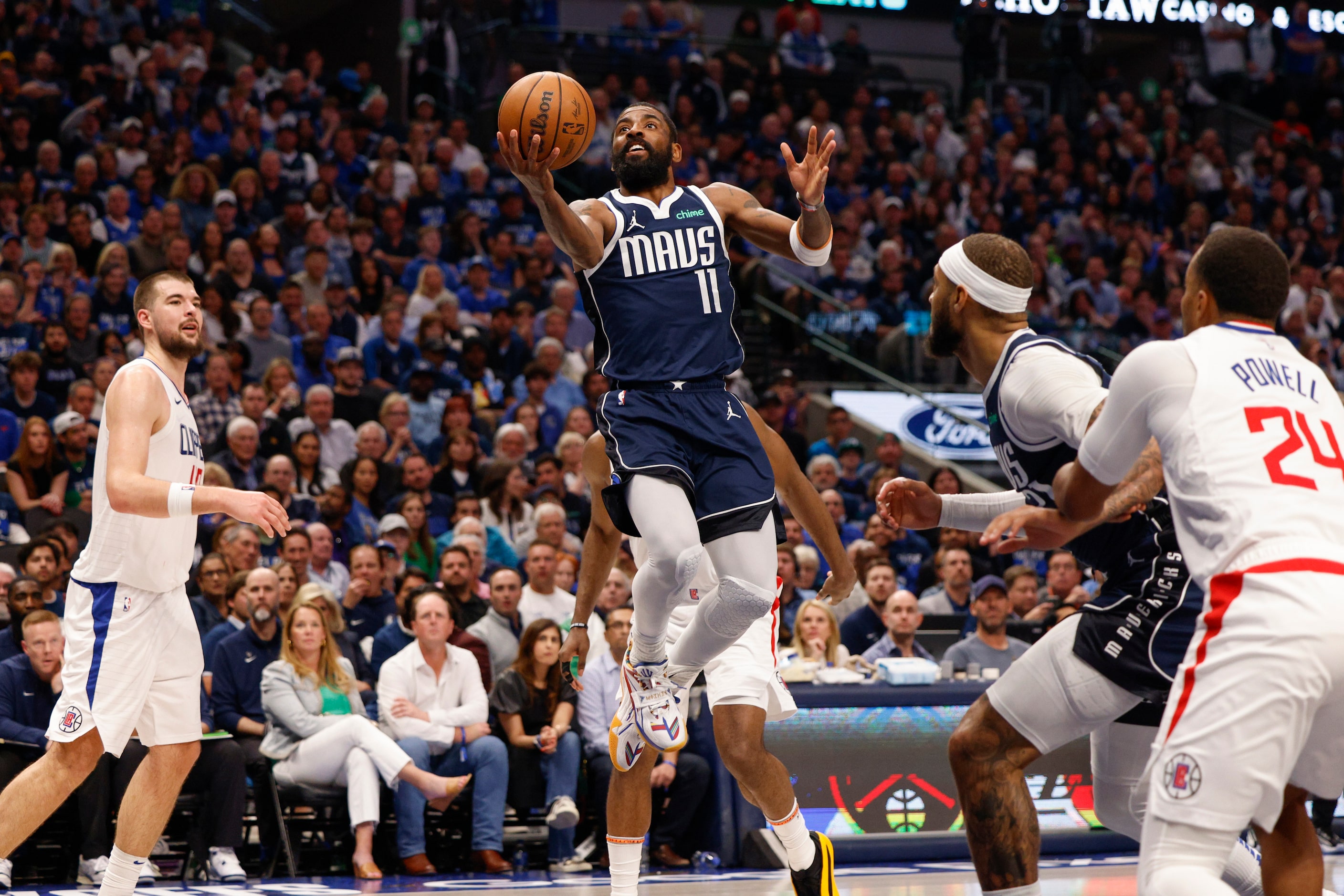 Dallas Mavericks guard Kyrie Irving (11) attempts a layup during the second half of Game 3...