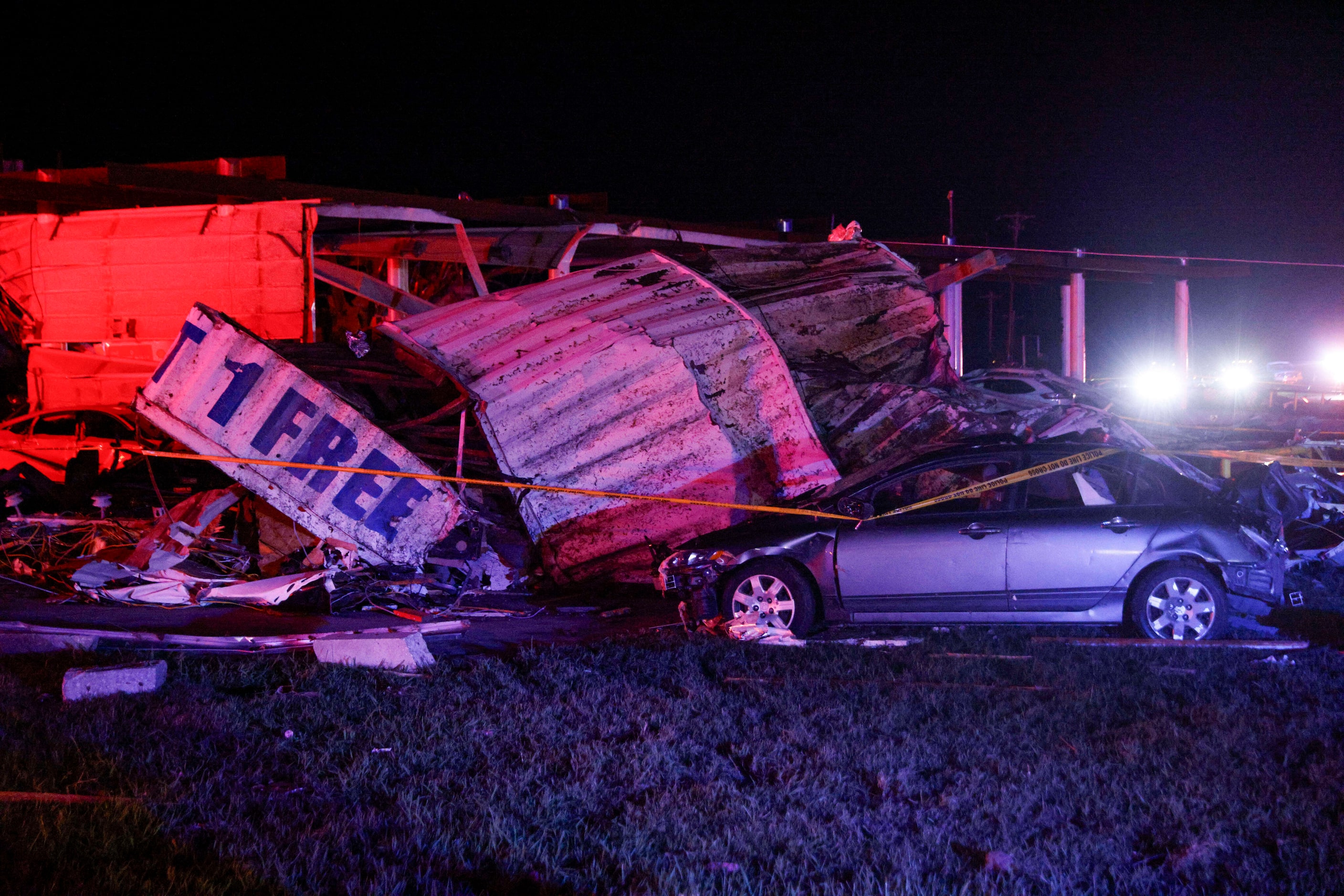 Mangled pieces of metal are seen on top of vehicle at a Shell gas station after a suspected...