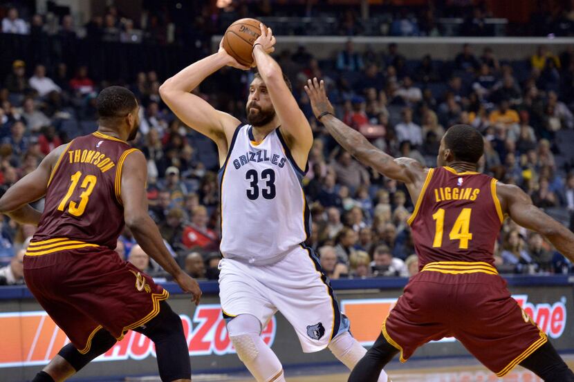 Memphis Grizzlies center Marc Gasol (33) controls the ball between Cleveland Cavaliers...