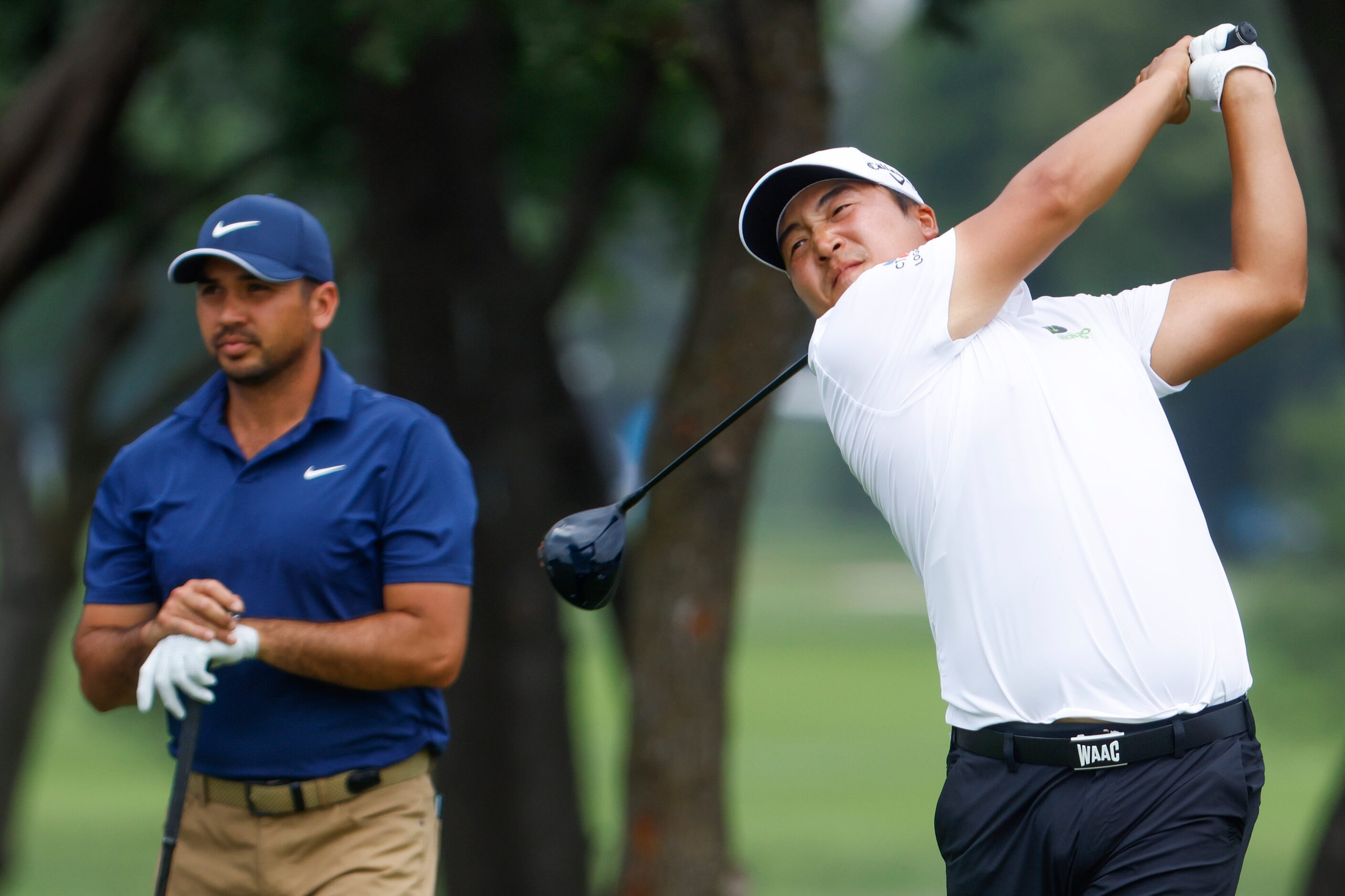 K.H. Lee tees off on the ninth hole as Jason Day (left) watches during the second round of...