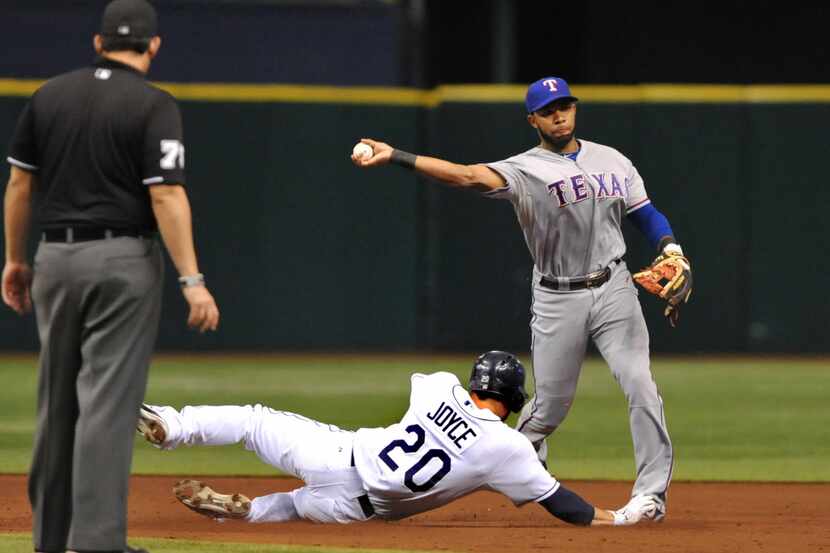 ST. PETERSBURG, FL - SEPTEMBER 19: Elvis Andrus #1 of the Texas Rangers throws to first base...