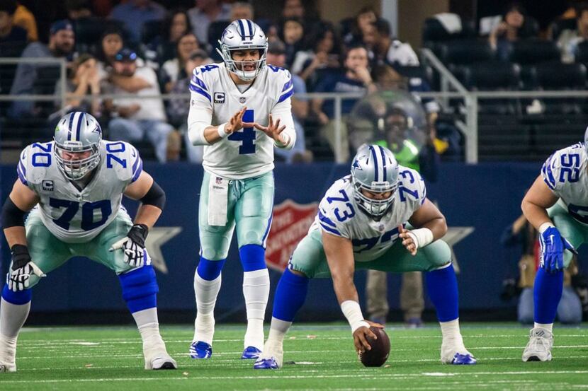 Dallas Cowboys quarterback Dak Prescott (4) lines up behind offensive guard Zack Martin...