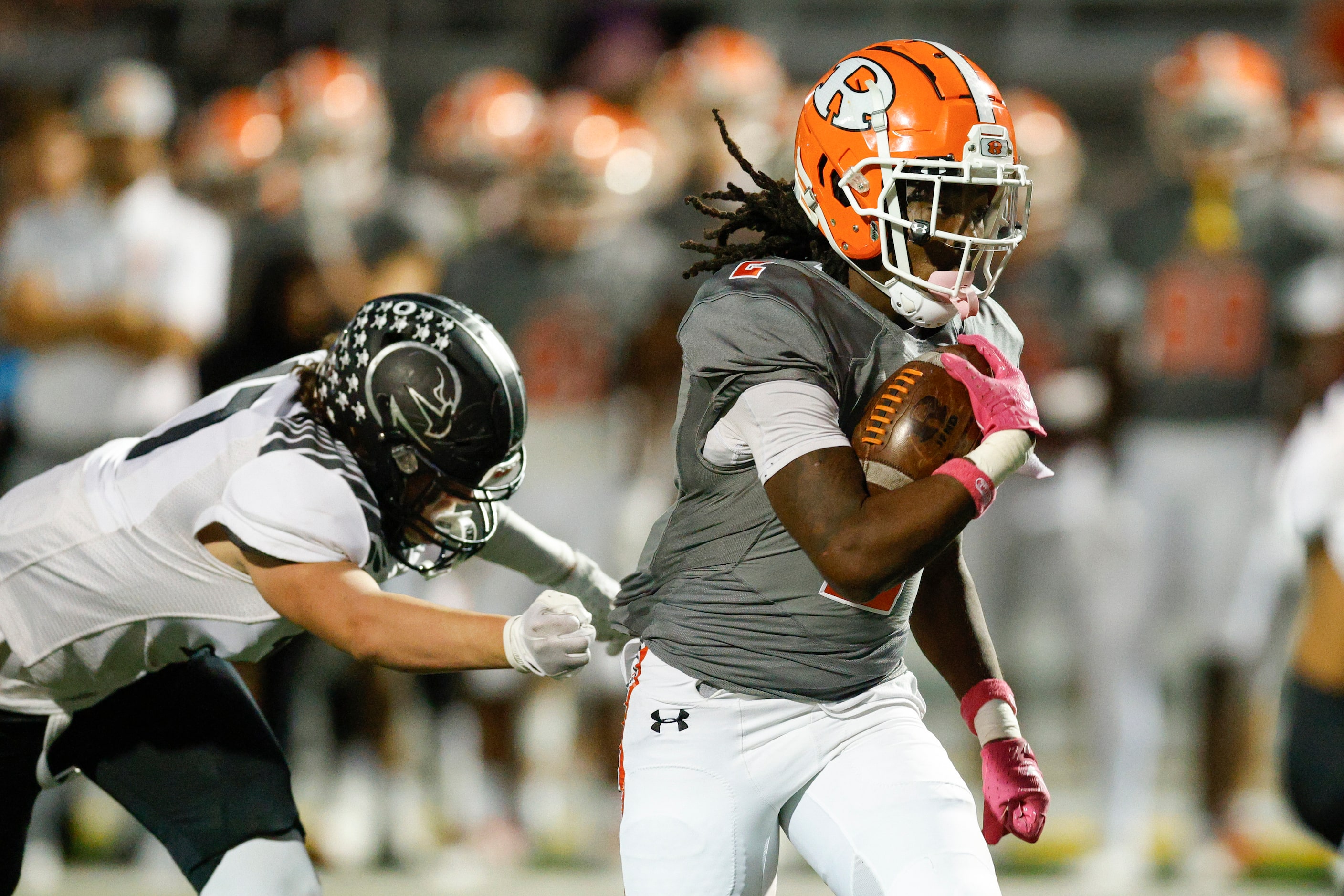 Rockwall running back Ashten Emory (2) runs through the tackle of North Forney’s Slaten...