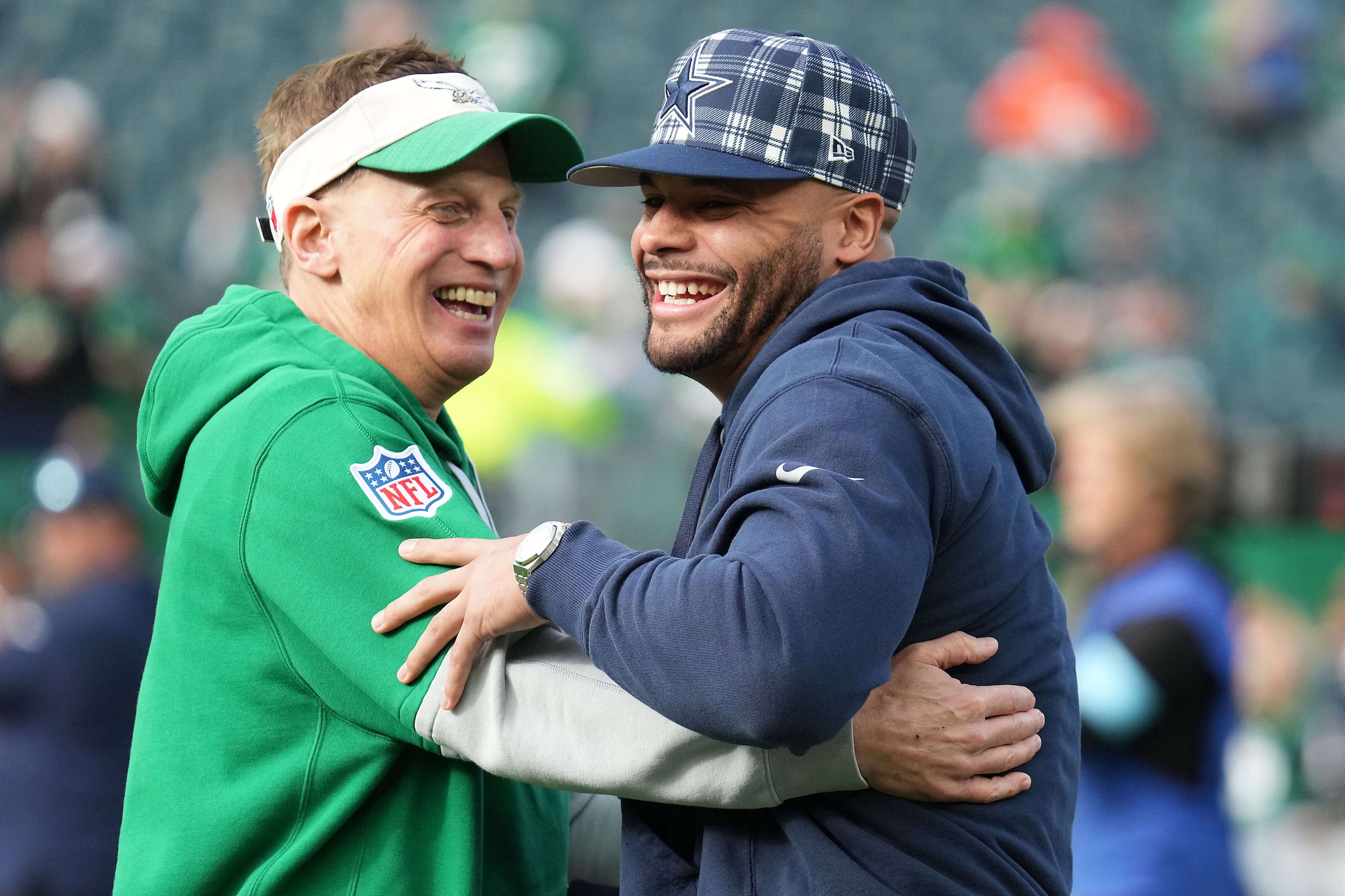 Philadelphia Eagles quarterbacks coach Doug Nussmeier hugs Dallas Cowboys quarterback Dak...