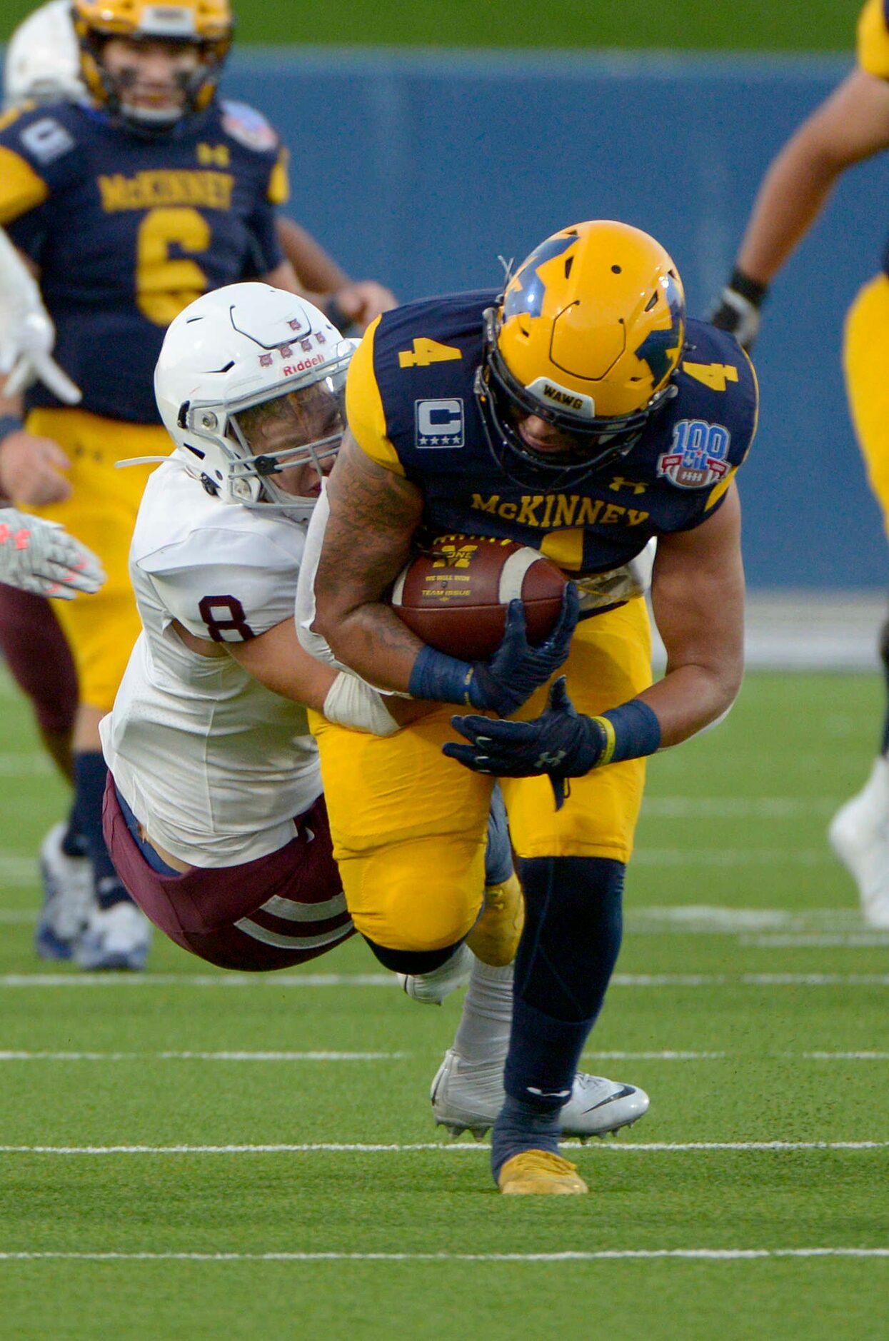 McKinneyÕs Joshua Dixon runs through a tackle attempt by PlanoÕs Gavin Brand in the first...