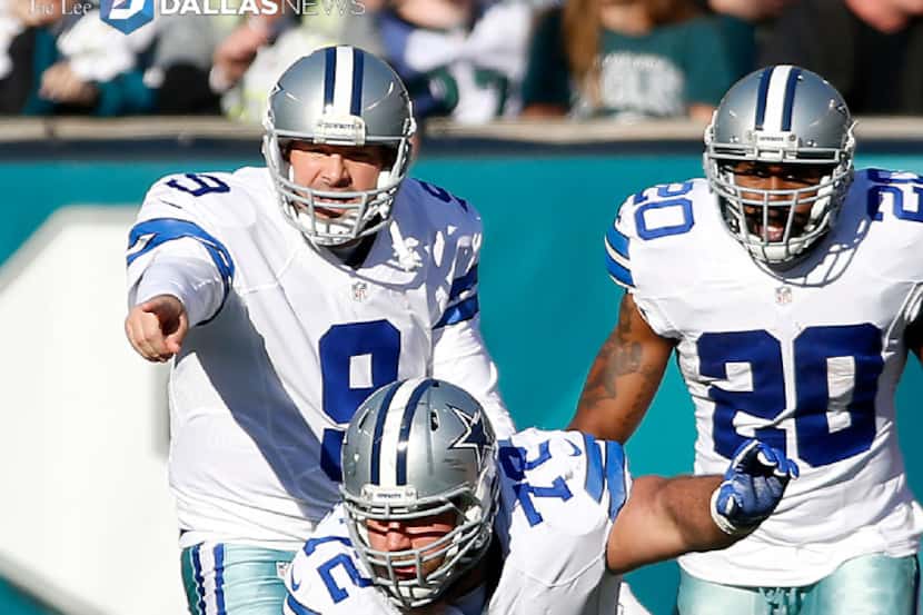 Dallas Cowboys quarterback Tony Romo (9) calls a play behind center Travis Frederick (72)...