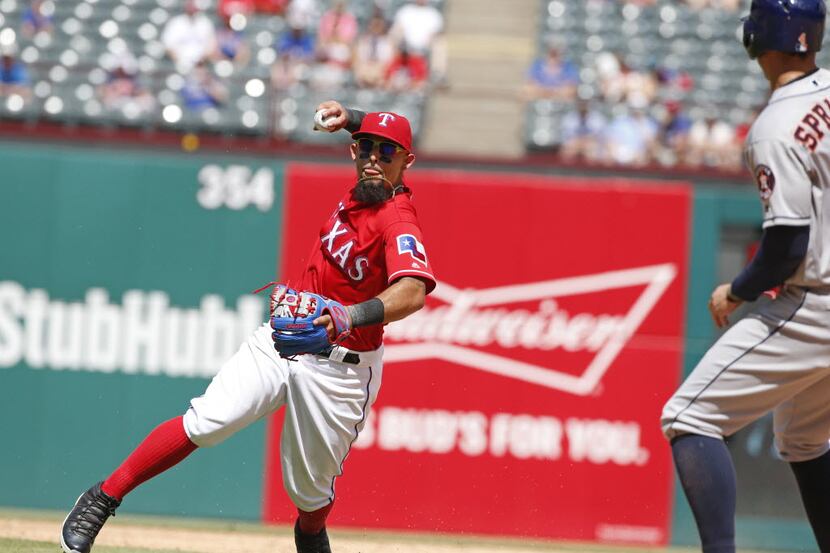 Texas Rangers second baseman Rougned Odor (12) fields the ball and throws for what ended up...