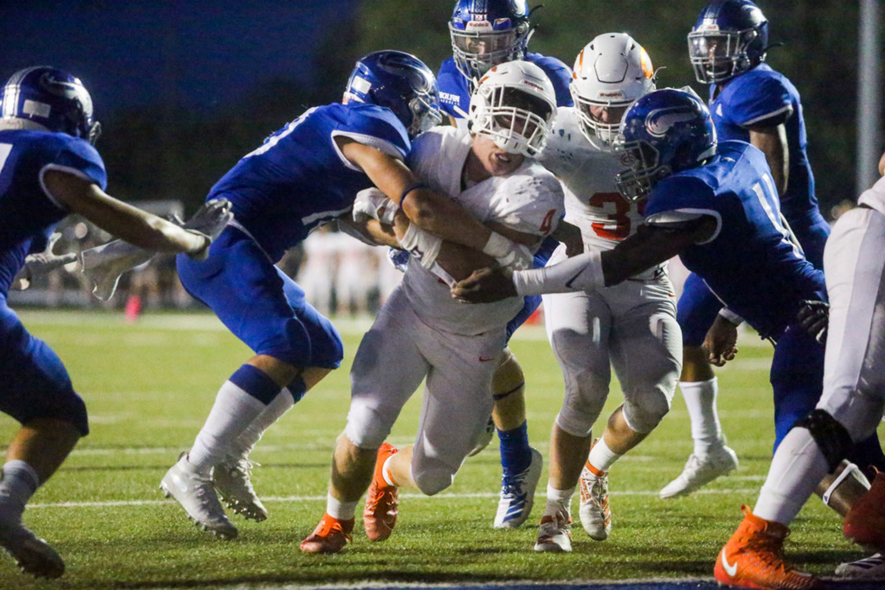 Celina running back Logan Point (4) carries the ball past Nolan Catholicâs defense for a...