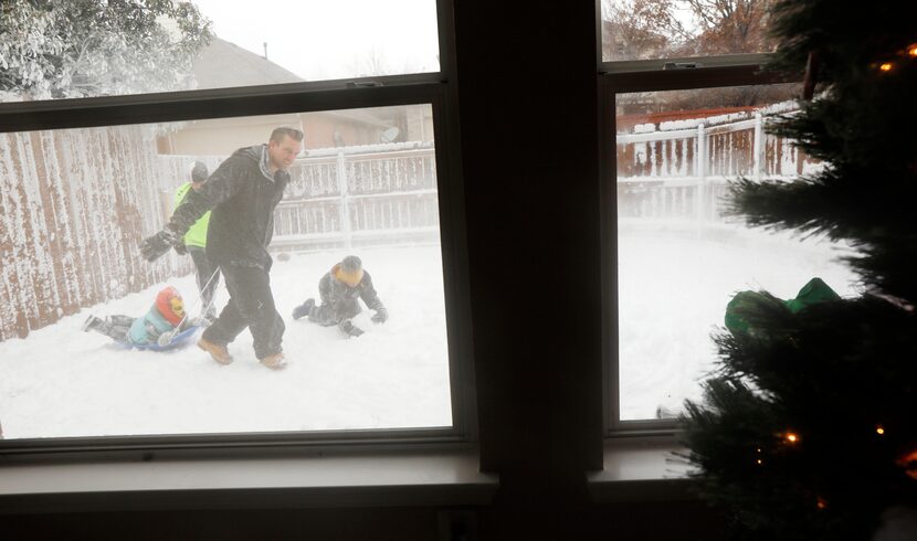 Jeramy Melchiorre, left, pulls his niece, Emmaline Gibson, 6, while his sons, Jude...