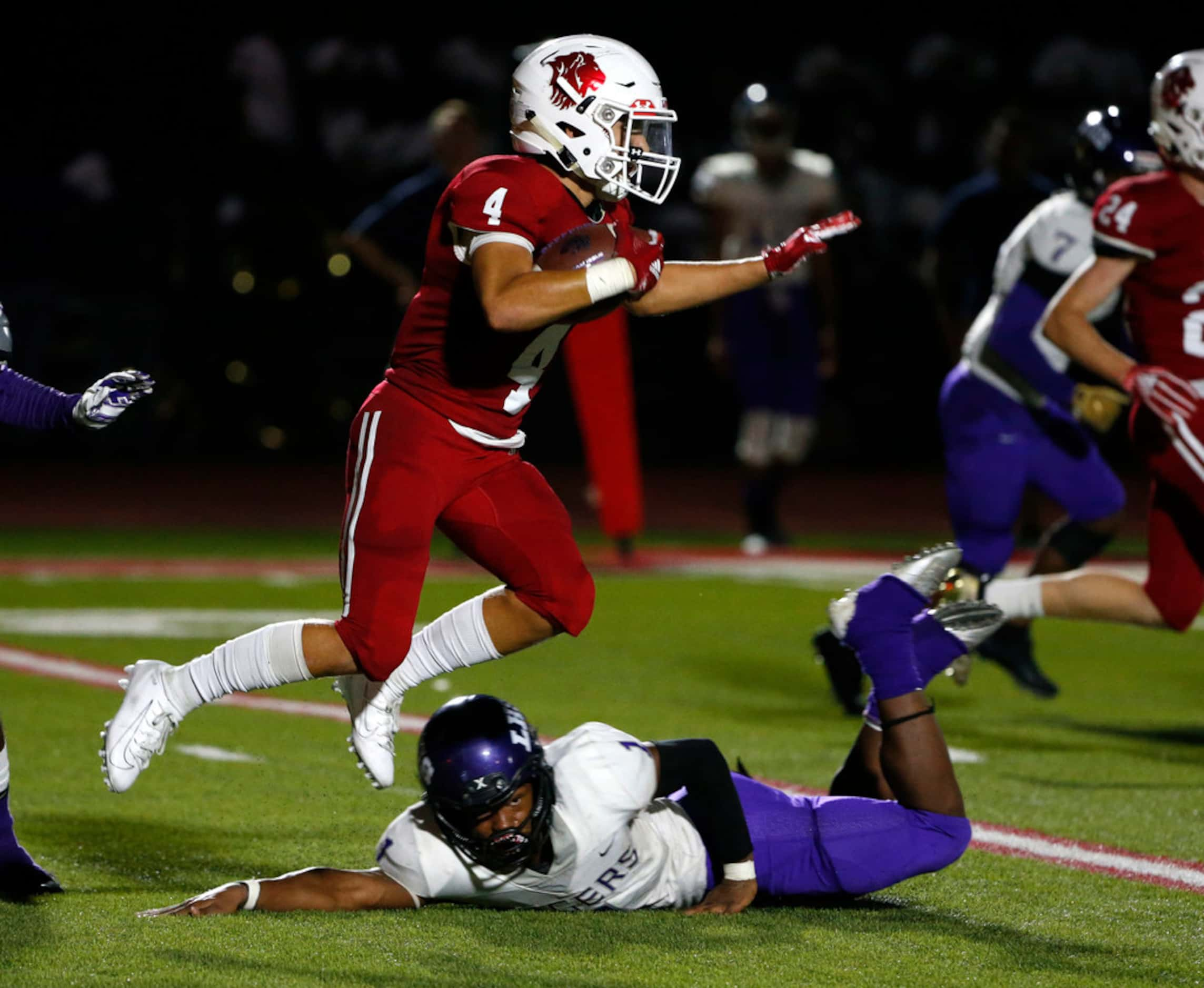 Grapevine Faith Christian's Davis Anderson (4) returns an interception as Lincoln's Timothy...