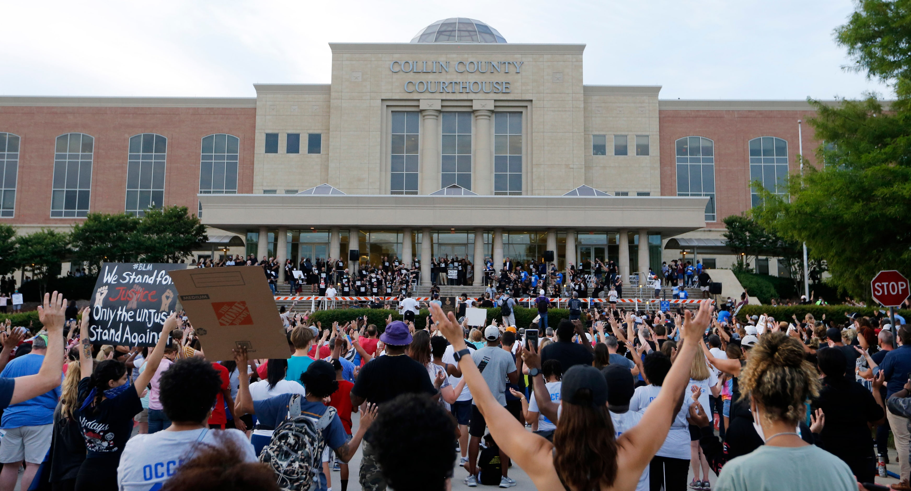 People stand as various pastors from local churches pray during "A Gathering of Our Collin...