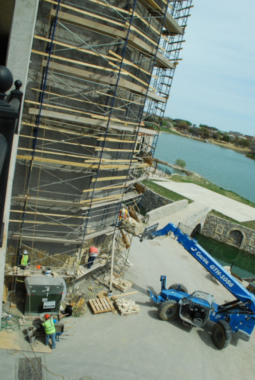 Construction workers peice together the shops and condos at Riva Harbor.