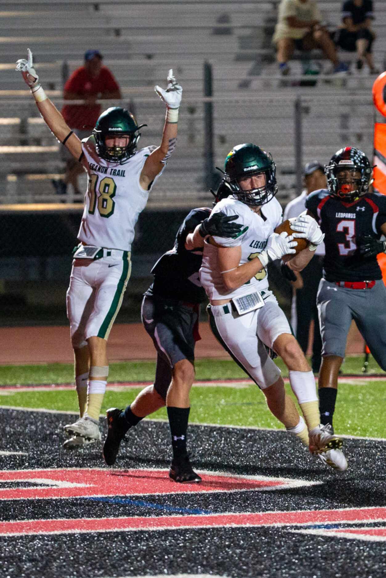 Lebanon Trail wide receiver Jason O'Brien pushes past defense to score a touchdown as...