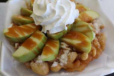 This is a Caramel Apple Funnel Cake. It comes with fresh apple slices, whip cream, and...