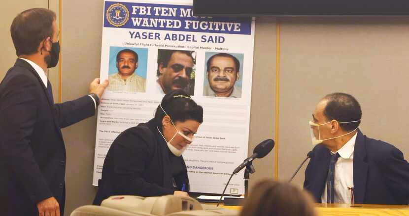 Yaser Said, 65, right, looked at the FBI Ten Most Wanted Fugitive poster, as he testified...