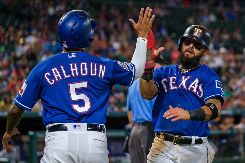 Texas Rangers second baseman Rougned Odor (12) celebrates with left fielder Willie Calhoun...