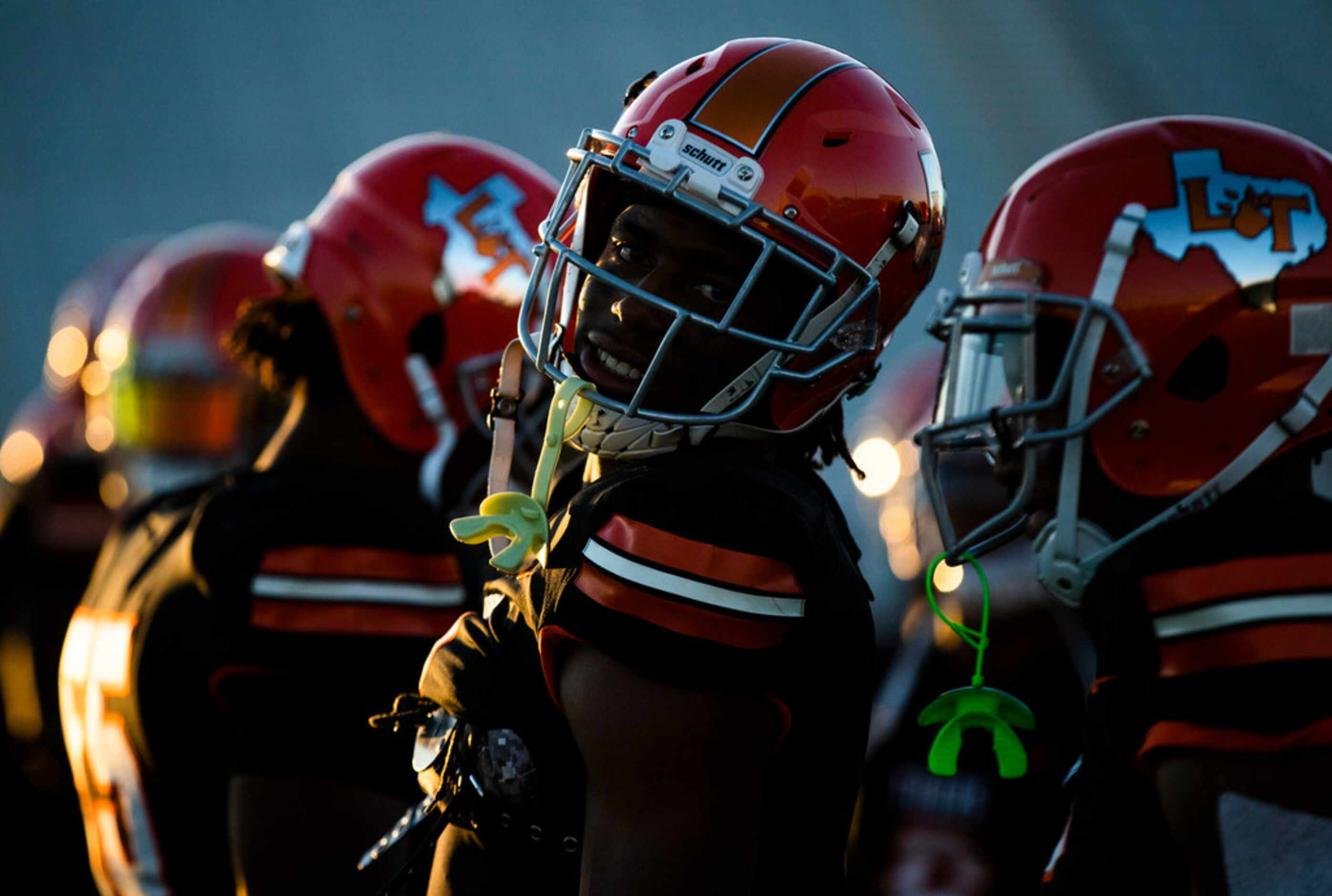 Lancaster players warm up before a District 6-5A Division I high school football game...