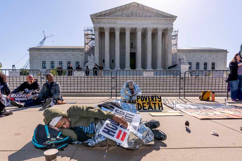 Activists demonstrate at the Supreme Court as the justices consider a challenge to rulings...
