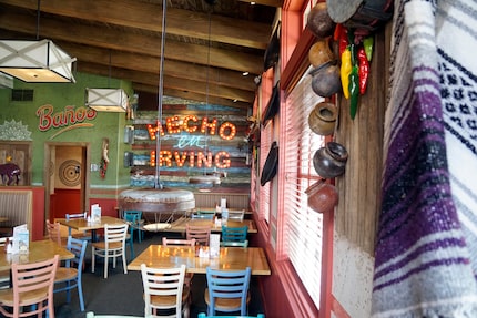 In one of the side rooms at the first Lupe Tortilla in North Texas, a light-up sign says...