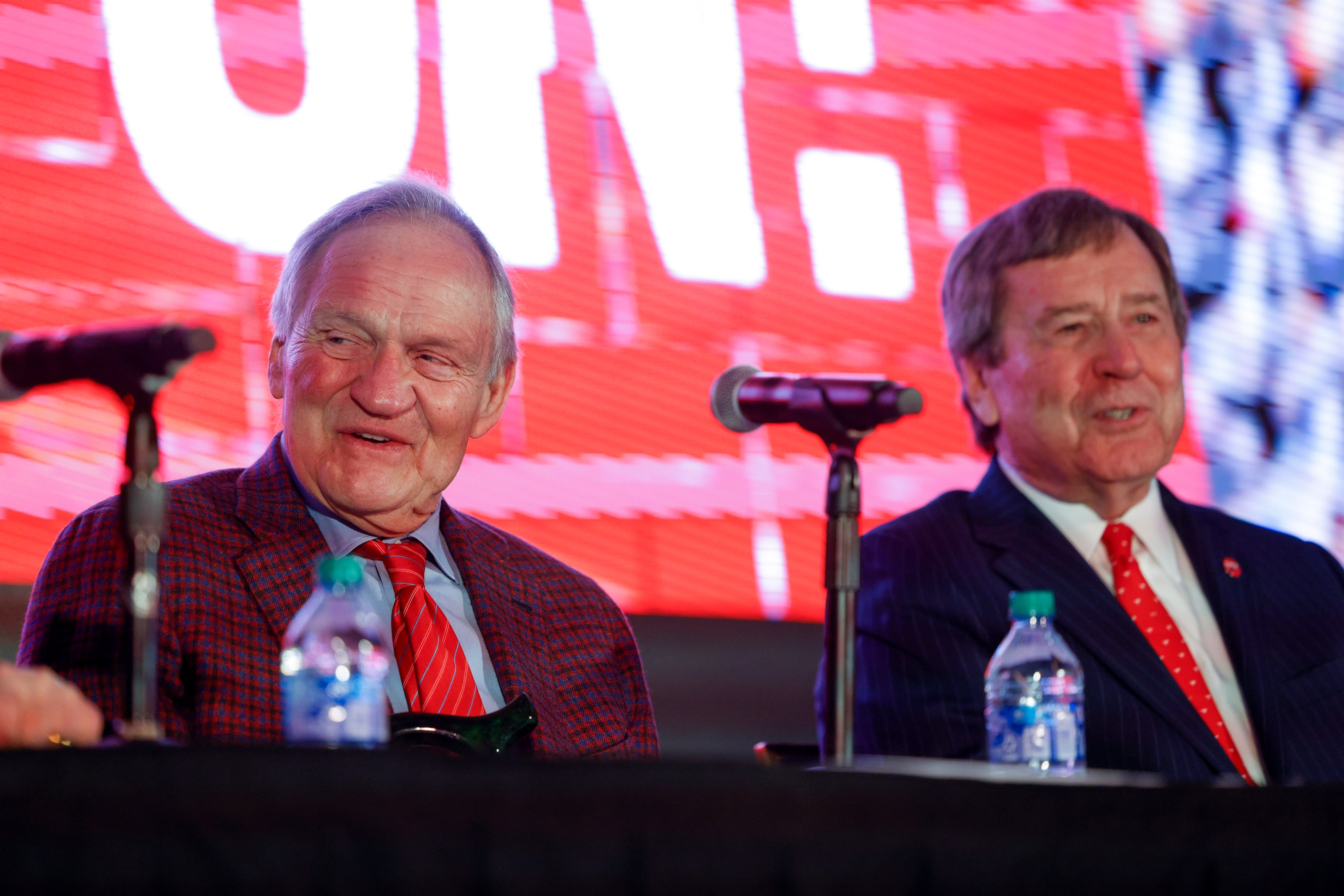 SMU alumnus Garry Weber (left) laughs with SMU President R. Gerald Turner during a press...