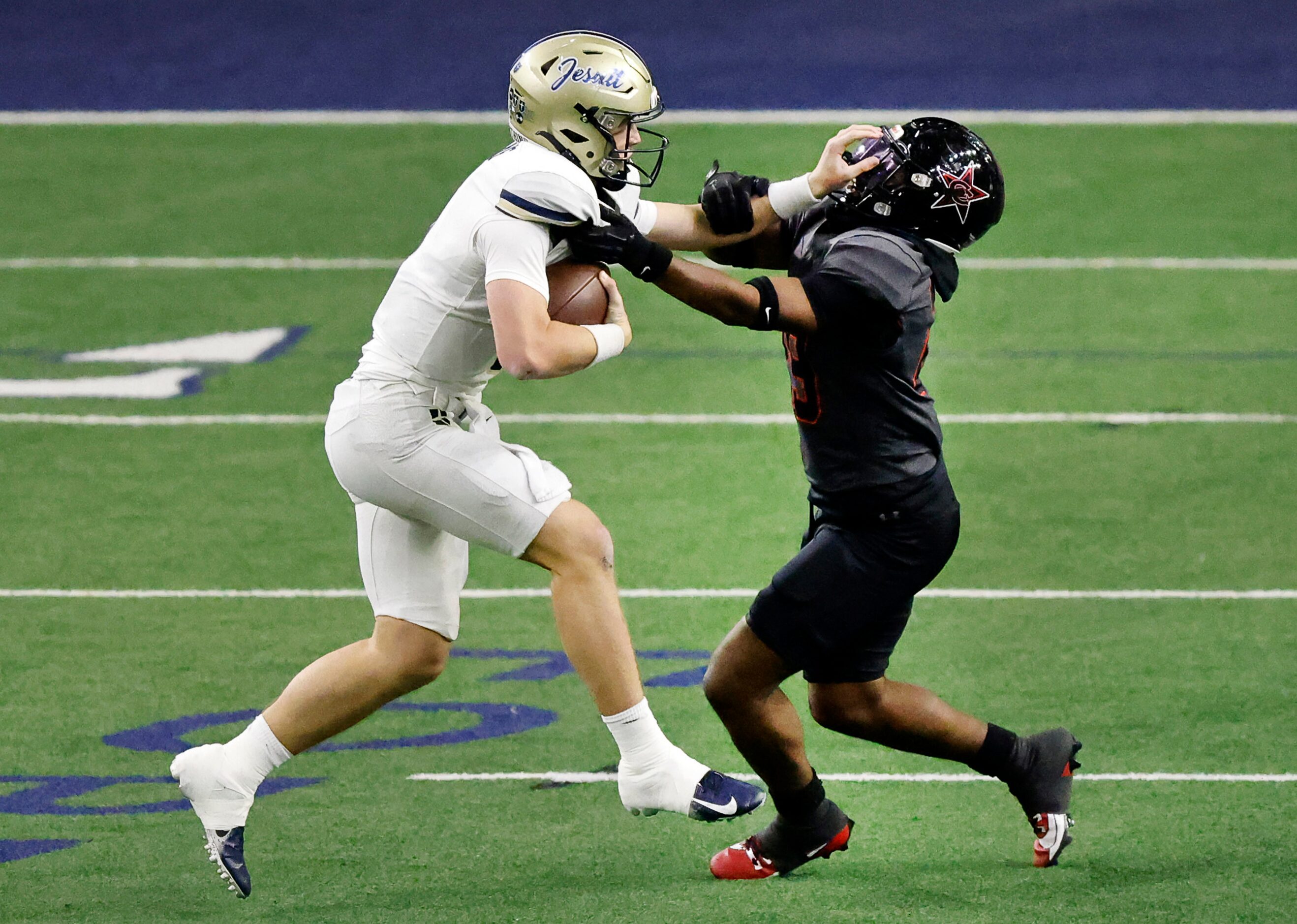 Coppell defensive lineman TJ Smith (right) sacks Jesuit quarterback Charlie Peters (9)...