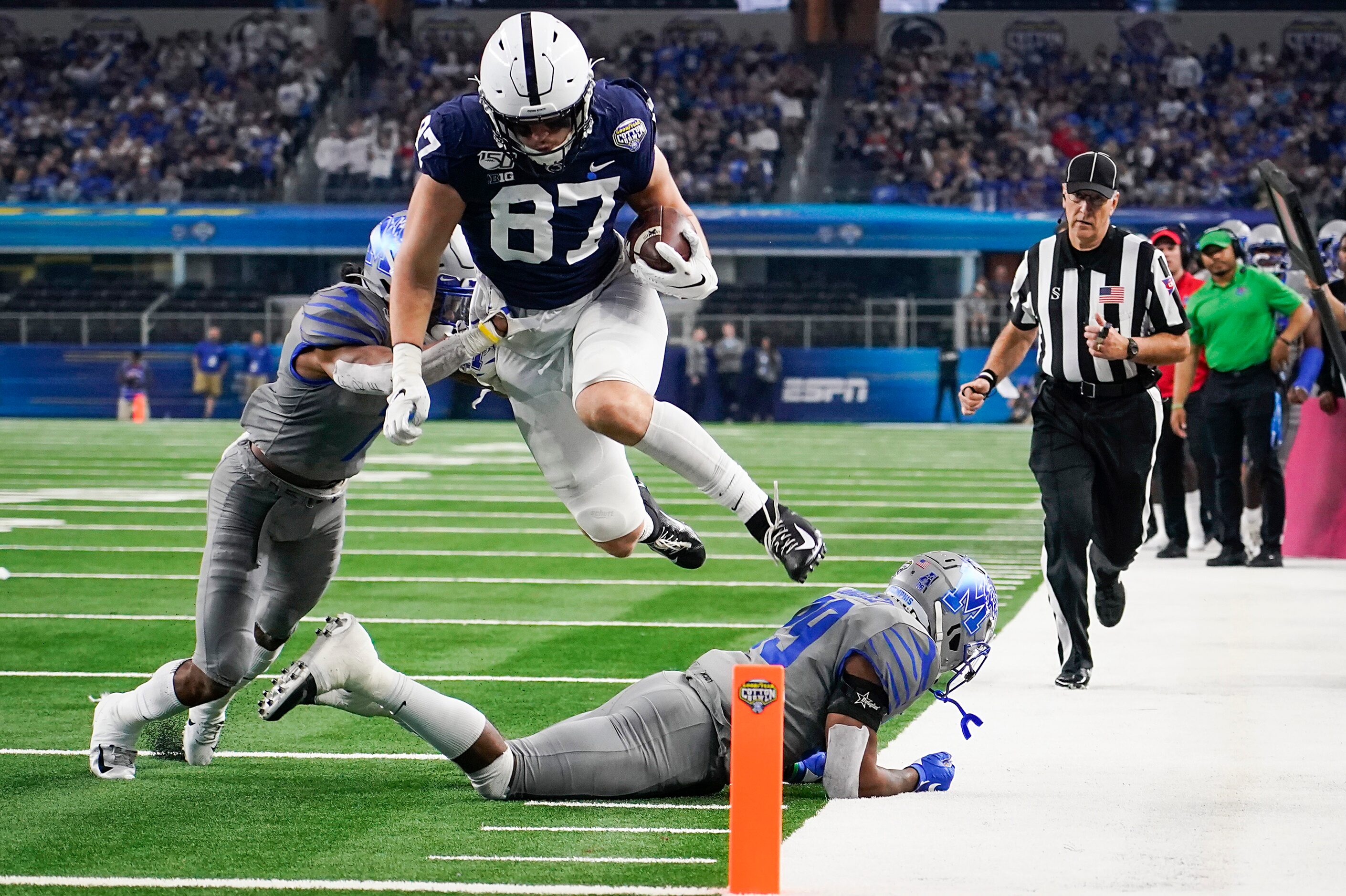 Penn State tight end Pat Freiermuth (87) leaps over Memphis defensive back Carlito Gonzalez...