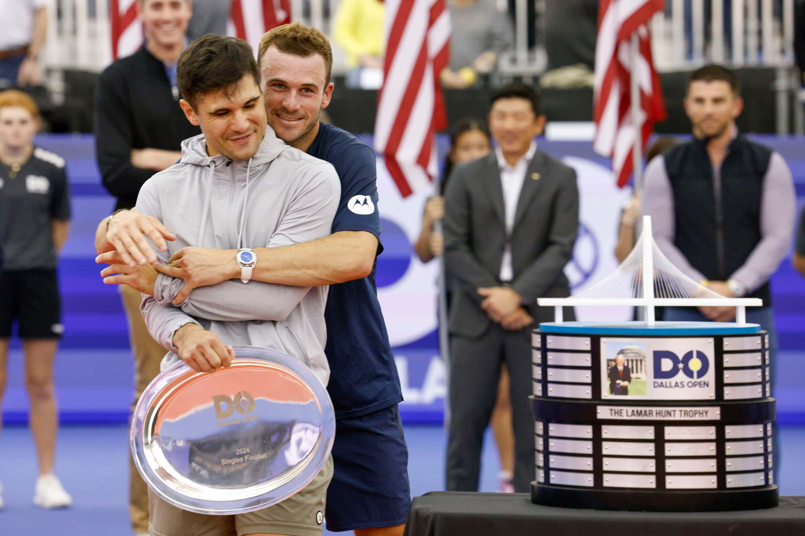 Tommy Paul of the U.S. (right) hugs Marcos Giron of the U.S. before posing for photos after...