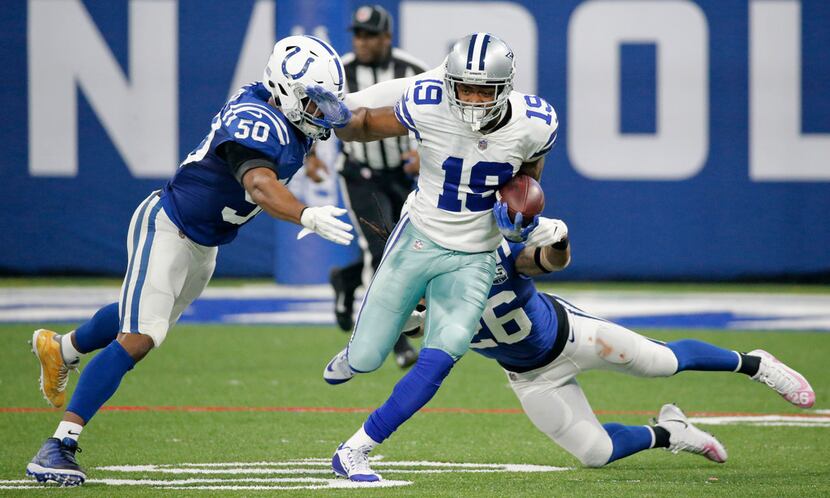 Dallas Cowboys wide receiver Amari Cooper (19) tries to maneuver around Indianapolis Colts...