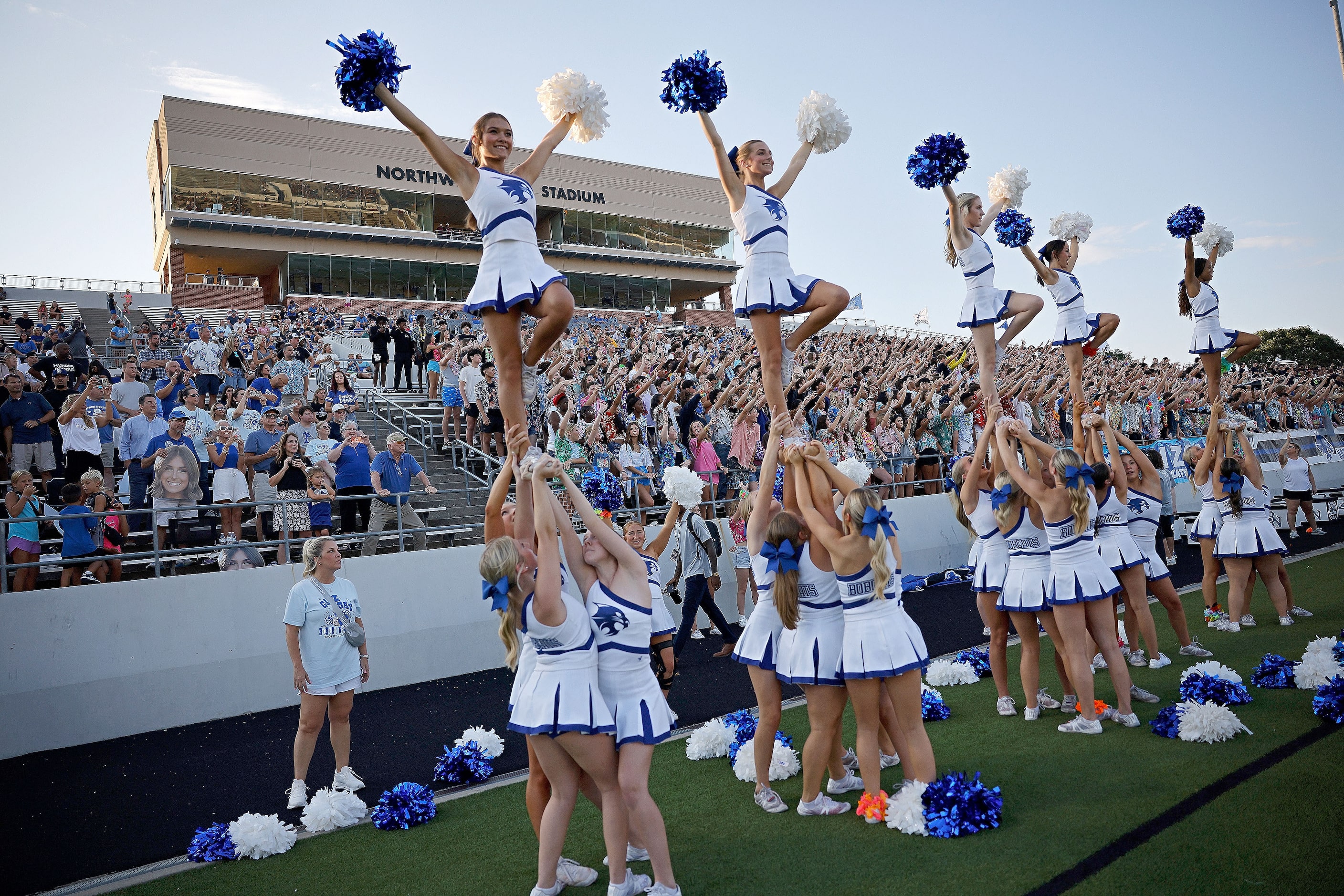 Byron Nelson's cheerleaders perform before a high school football game against Lewisville at...