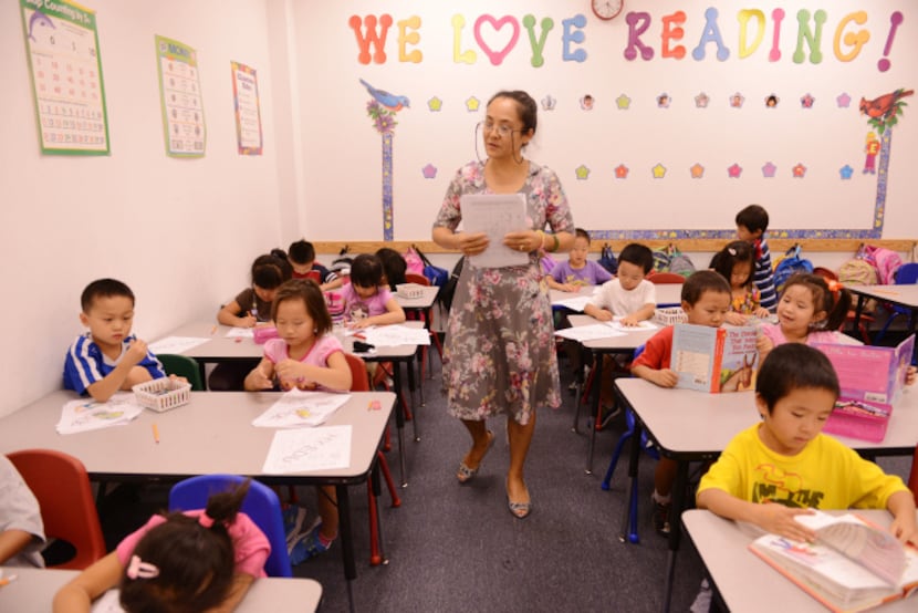 Principal Wen Yi teaches a class at HuaYi Education, a Chinese school offering supplemental...