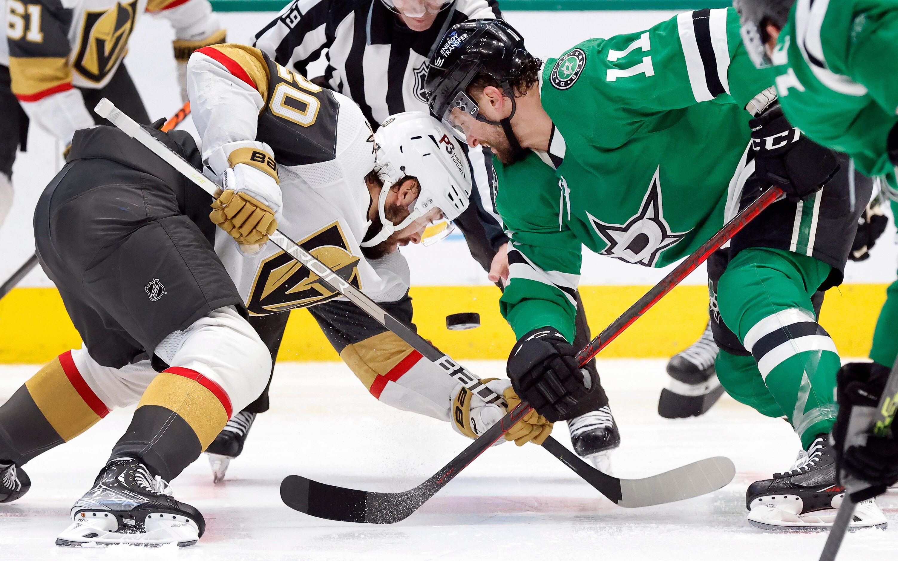 Dallas Stars center Luke Glendening (11) faces off against Vegas Golden Knights center...