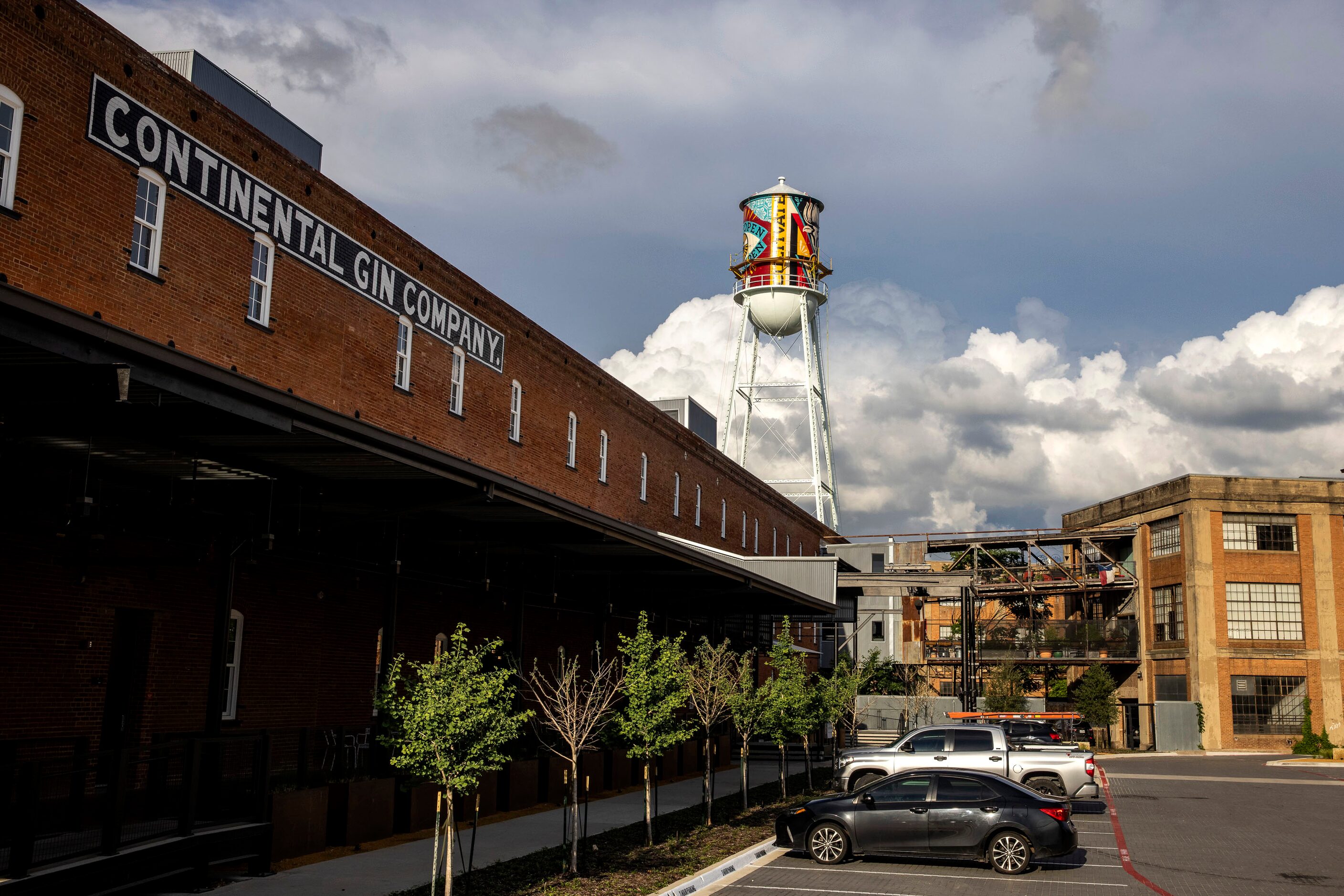 A new mural by Shepard Fairey appears on the side of a water tower by the Continental Gin...