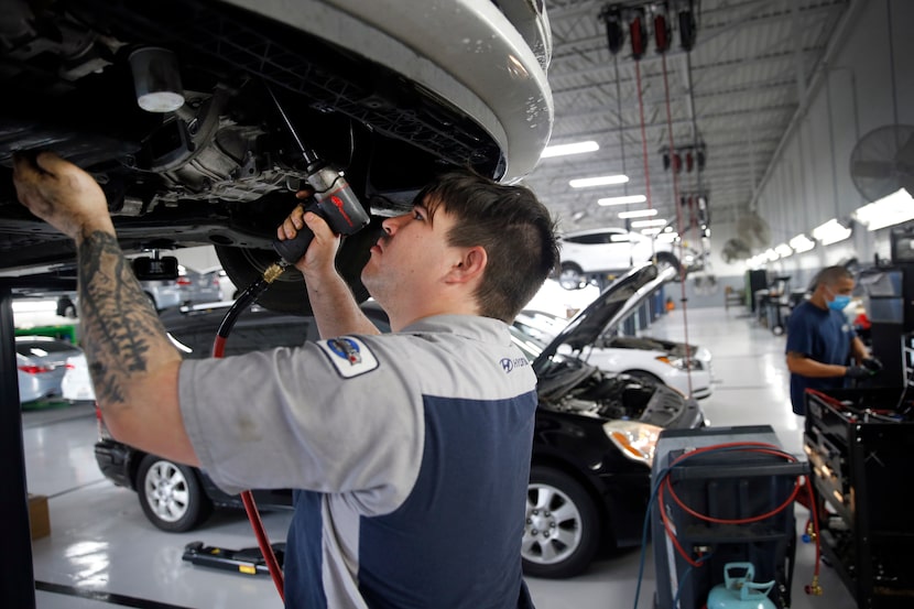 Automotive technician John Wilkins works on an engine in one of the garages at Huffines...