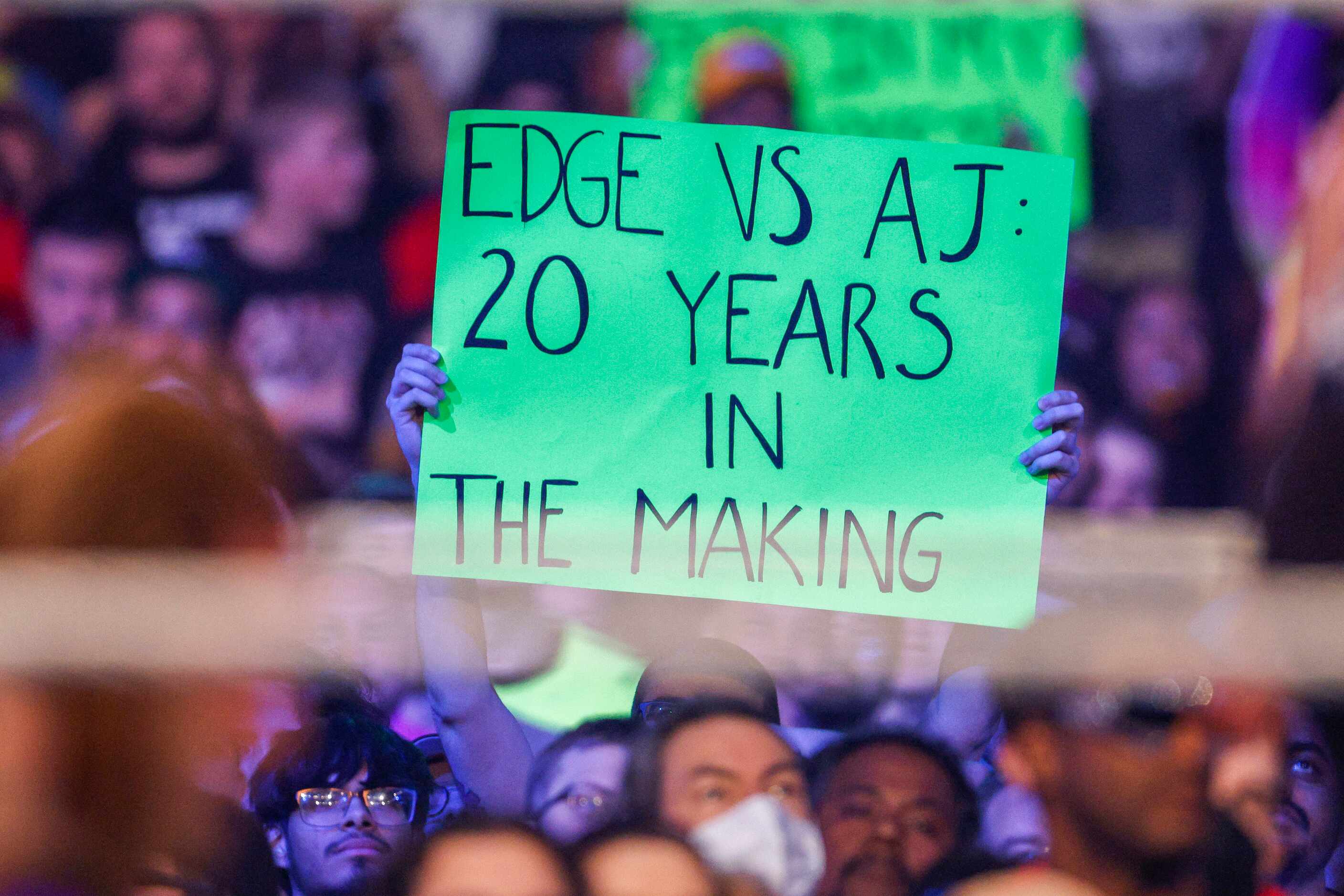A fan raises a sign during a match between Edge and AJ Styles at WrestleMania Sunday at AT&T...