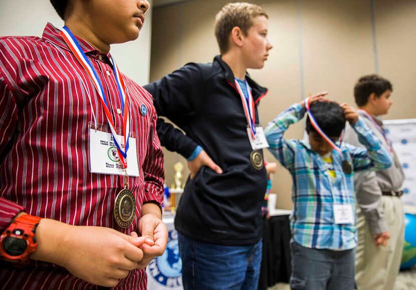  Top 10 finalists put on their medals during the National Geographic 2016 State Geography...