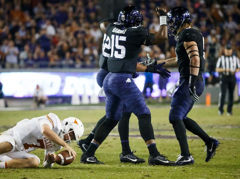 TCU linebacker Ty Summers (42) celebrates with defensive ends Ben Banogu (15) and Mat Boesen...