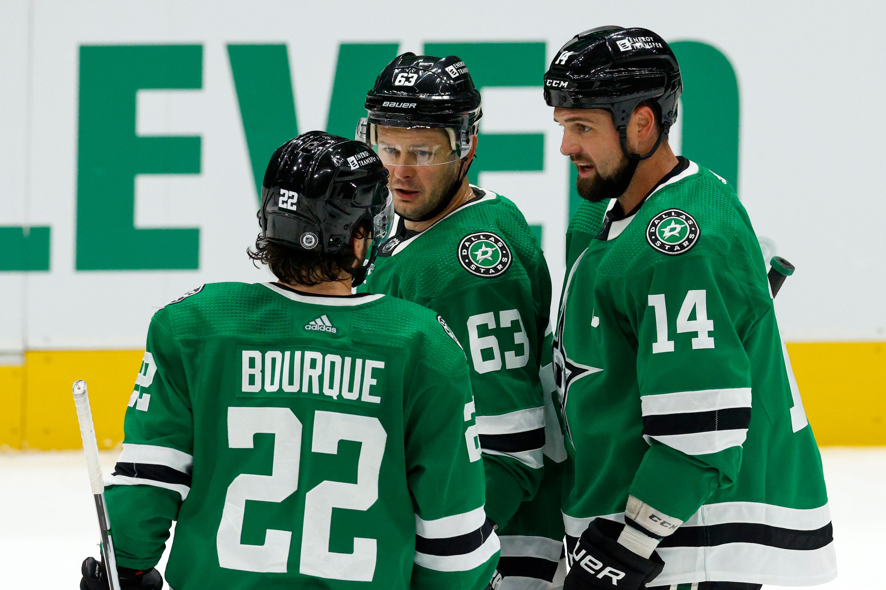 Dallas Stars center Mavrik Bourque (22) talks with right wing Evgenii Dadonov (63) and left...