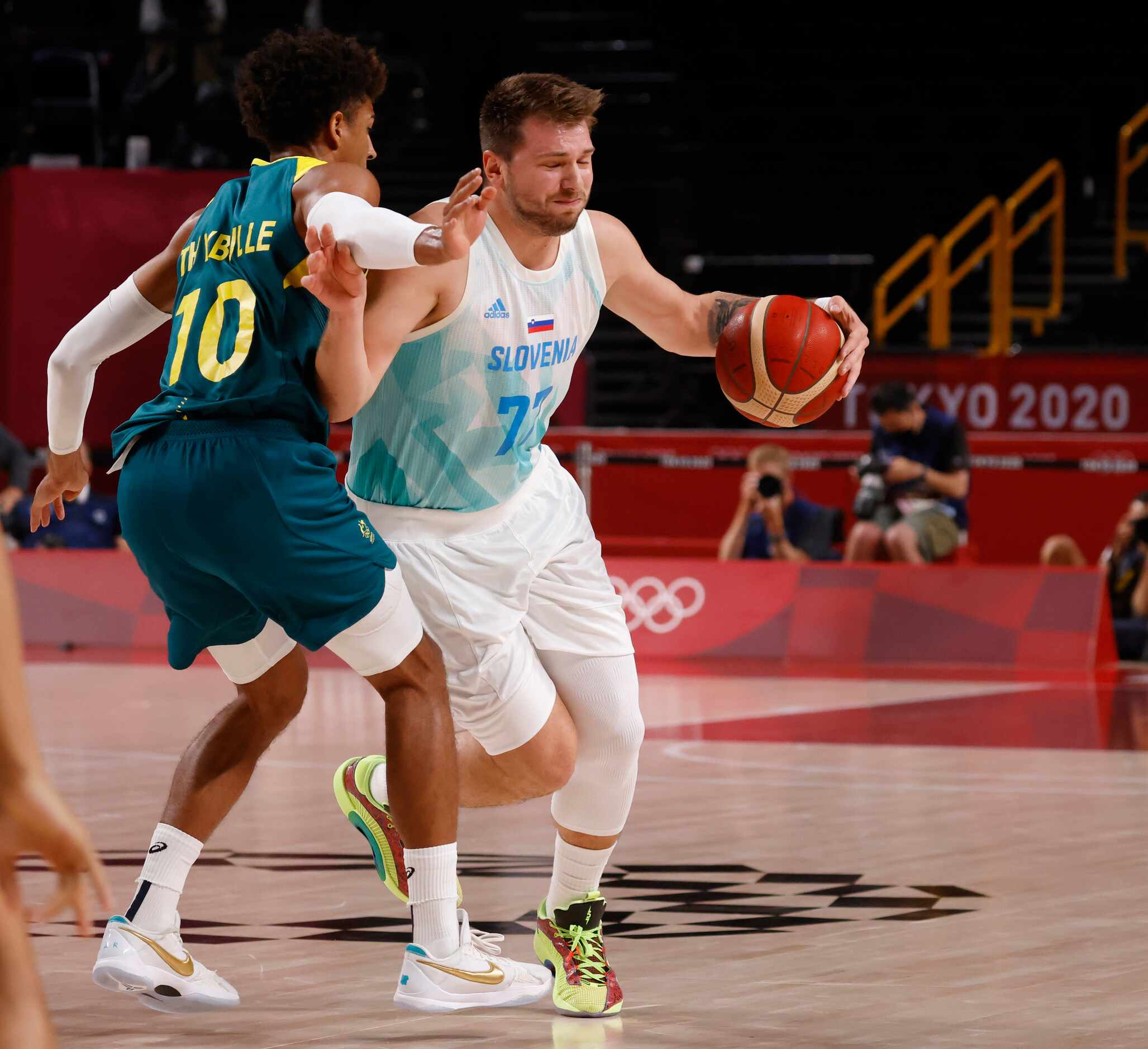 Slovenia’s Luka Doncic (77) drives on Australia’s Matisse Thybulle (10) during the first...