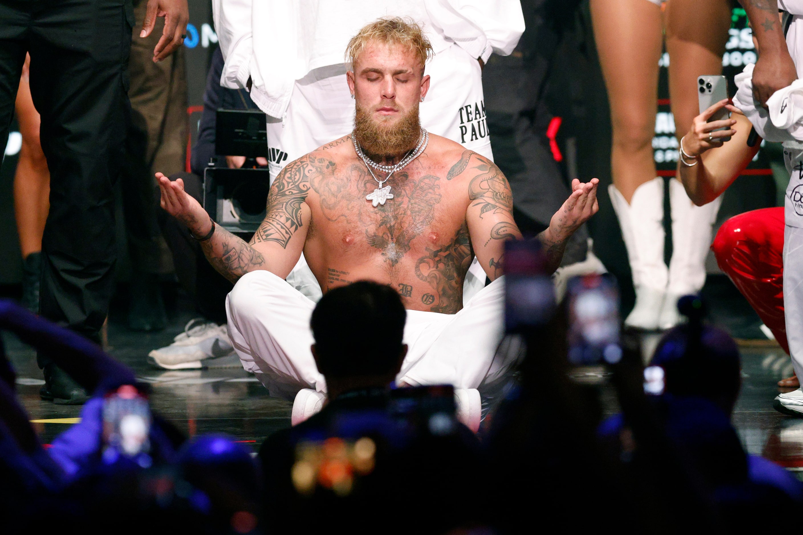 Jake Paul meditates after being slapped by Mike Tyson during public weigh-ins ahead of their...