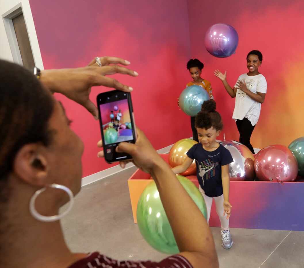 Philicia Carter-Blue, left, takes a photograph of 10-year-old J'Avia Carter-Blue, 4-year-old...