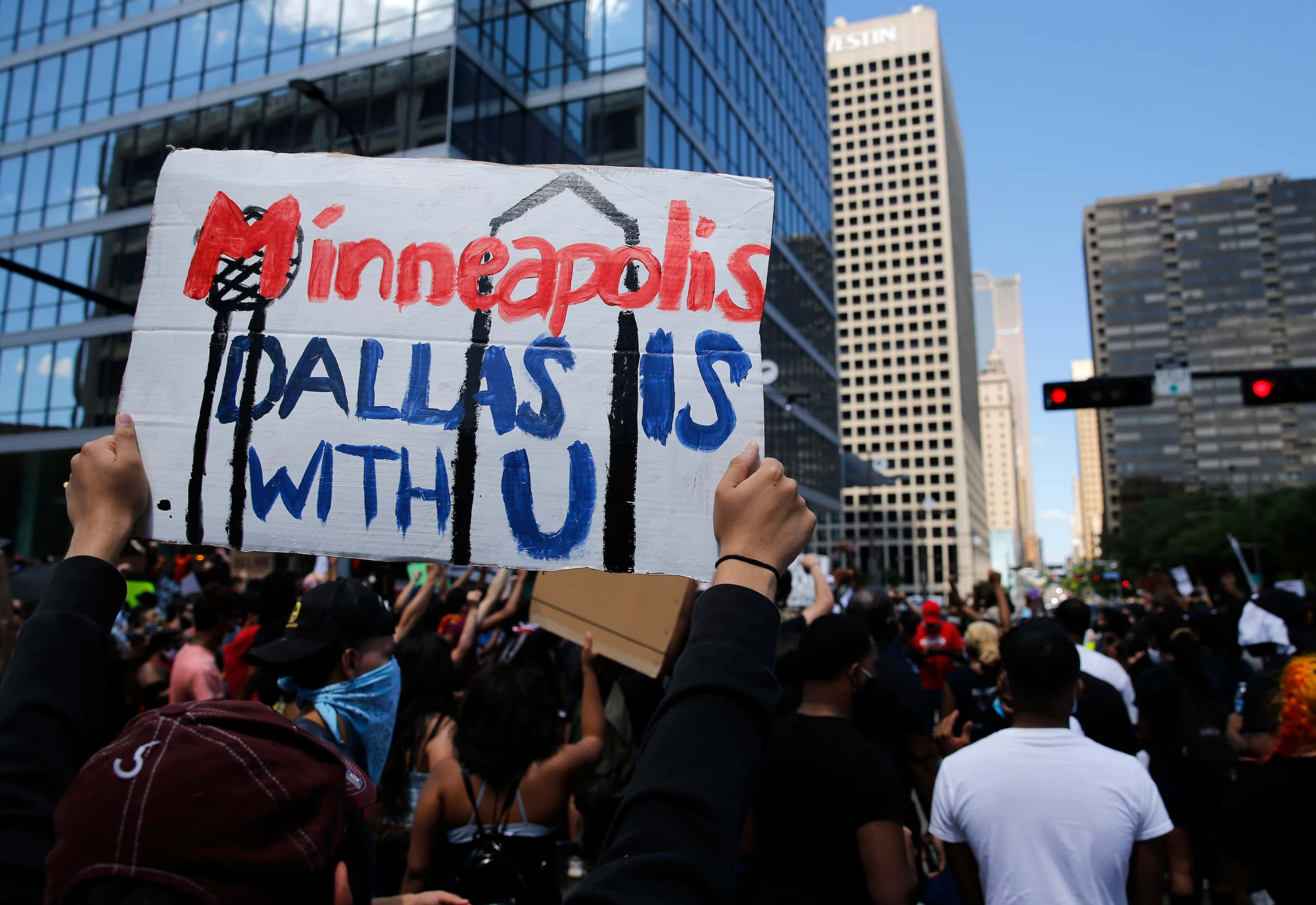 Protesters rally during a demonstration against police brutality in downtown Dallas, on...