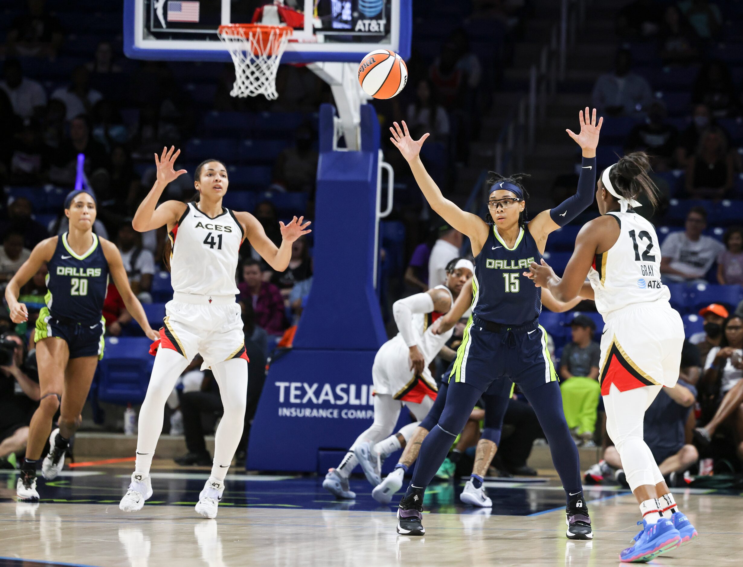 Las Vegas Aces guard Chelsea Gray (12) passes the ball over Dallas Wings guard Allisha Gray...