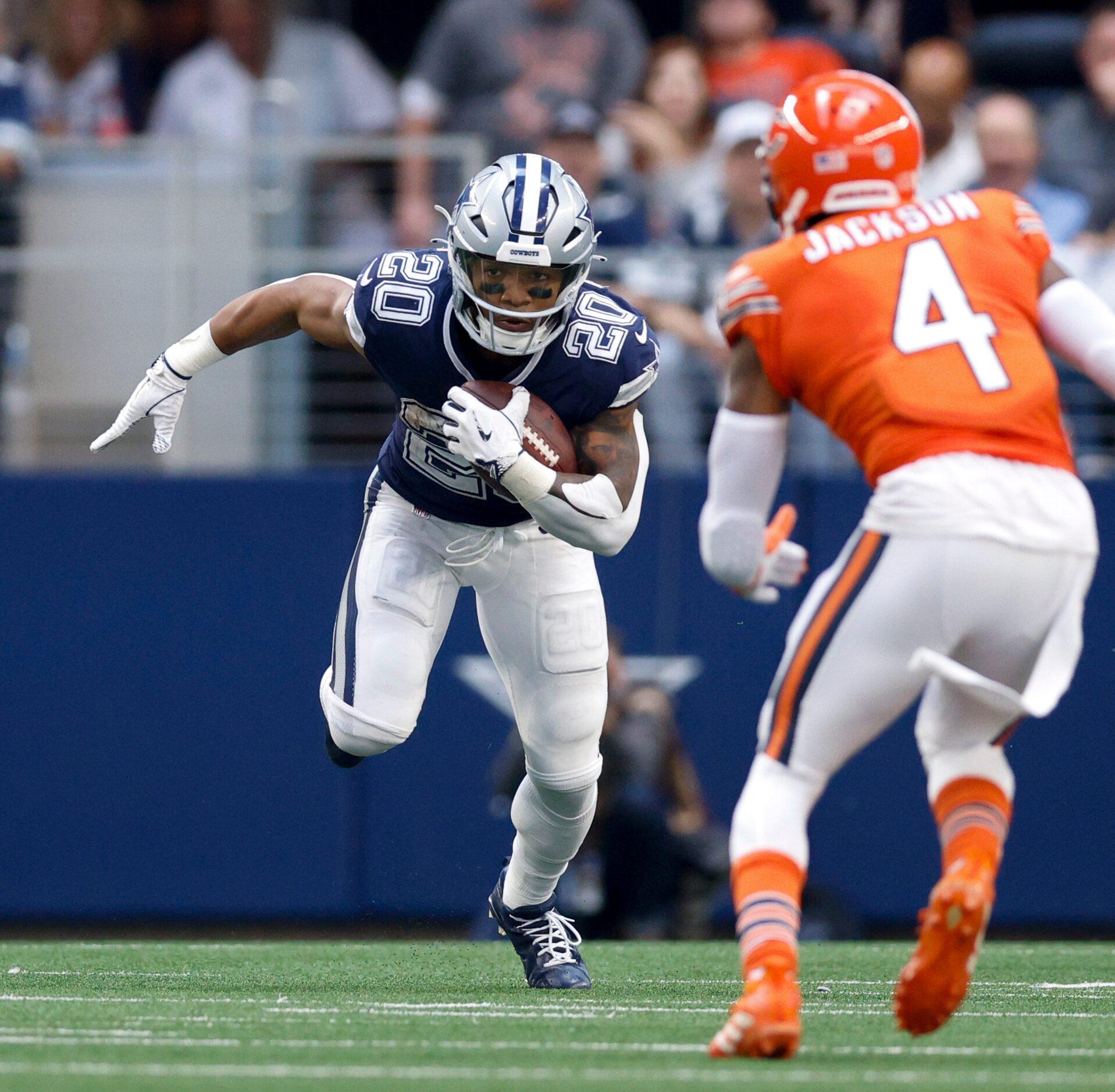 Dallas Cowboys running back Tony Pollard (20) runs the ball against a defending Chicago...