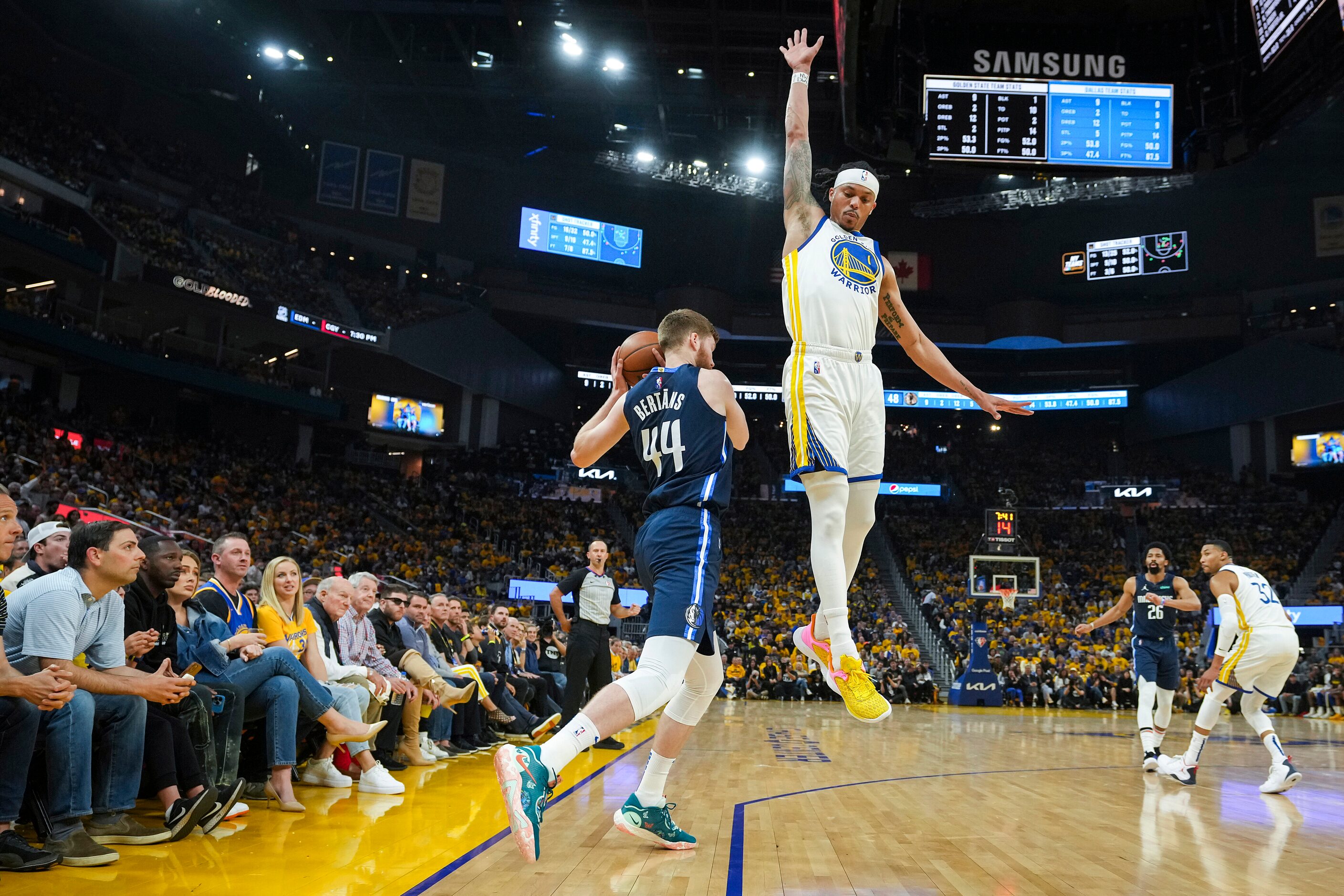 A pump fake by Dallas Mavericks forward Davis Bertans (44) gets Golden State Warriors guard...