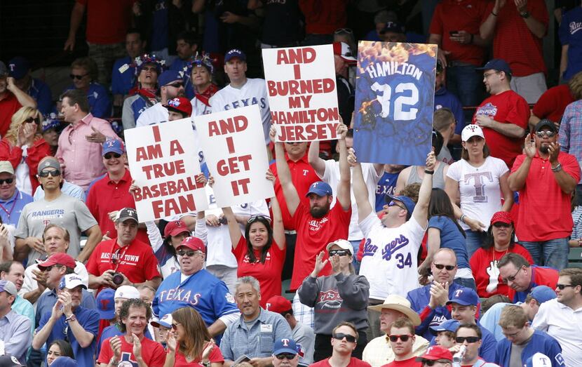 Apr 5, 2013; Arlington, TX, USA; Texas Rangers fans hold up signs about Los Angeles Angels...