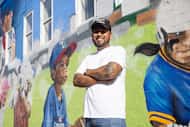 Fort Worth artist Juan Velázquez poses for a photo following the unveiling of his mural...