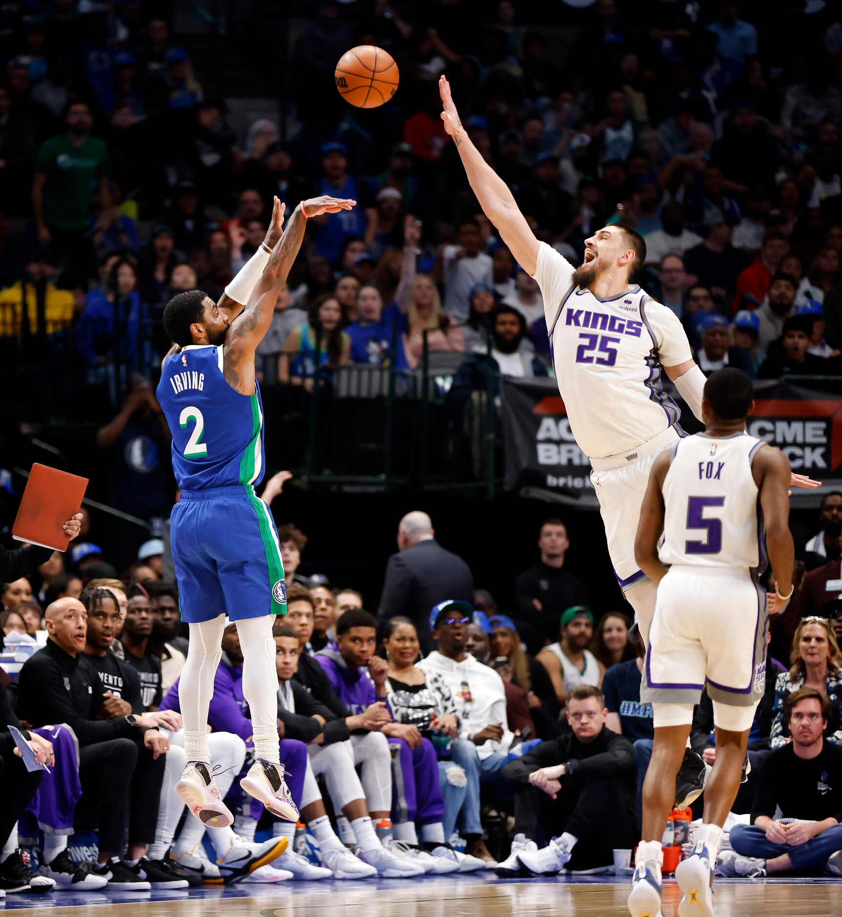 Dallas Mavericks guard Kyrie Irving (2) hits a three-pointer over Sacramento Kings center...