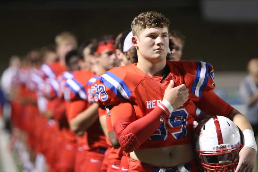 Midlothian Heritage defensive lineman Preston Smith lV (99) pauses with other Jaguars during...